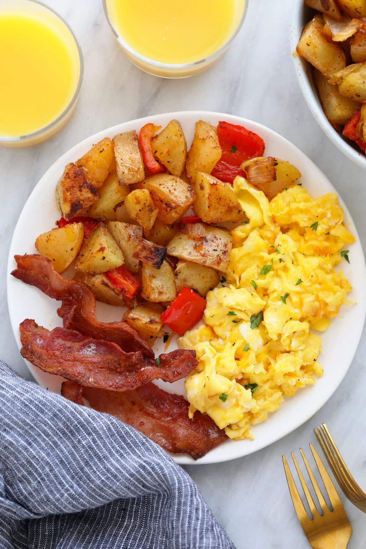 Scrammbled eggs, home-style potatoes, and bacon dish